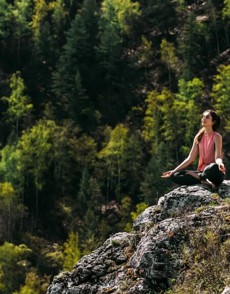 Attractive woman doing yoga. Healthy lifestyle. Woman doing yoga in the mountains.