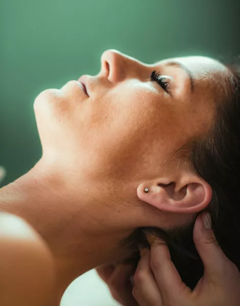 Neck massage in a massage salon, woman having a relaxing neck massage. Neck massage in a massage salon, woman having a relaxing neck massage.